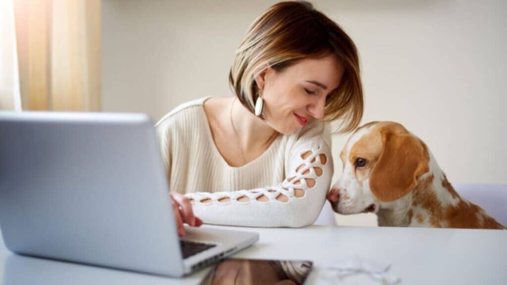 woman at the computer with her dog