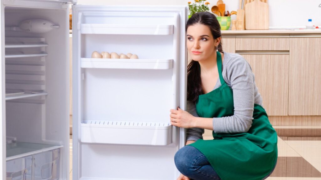 A Young Woman Cleaning Refrigerator