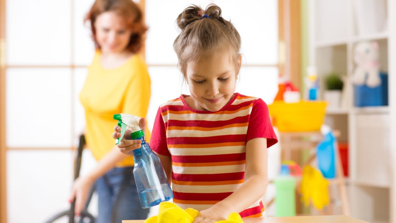 child girl and mother make cleaning in room at home