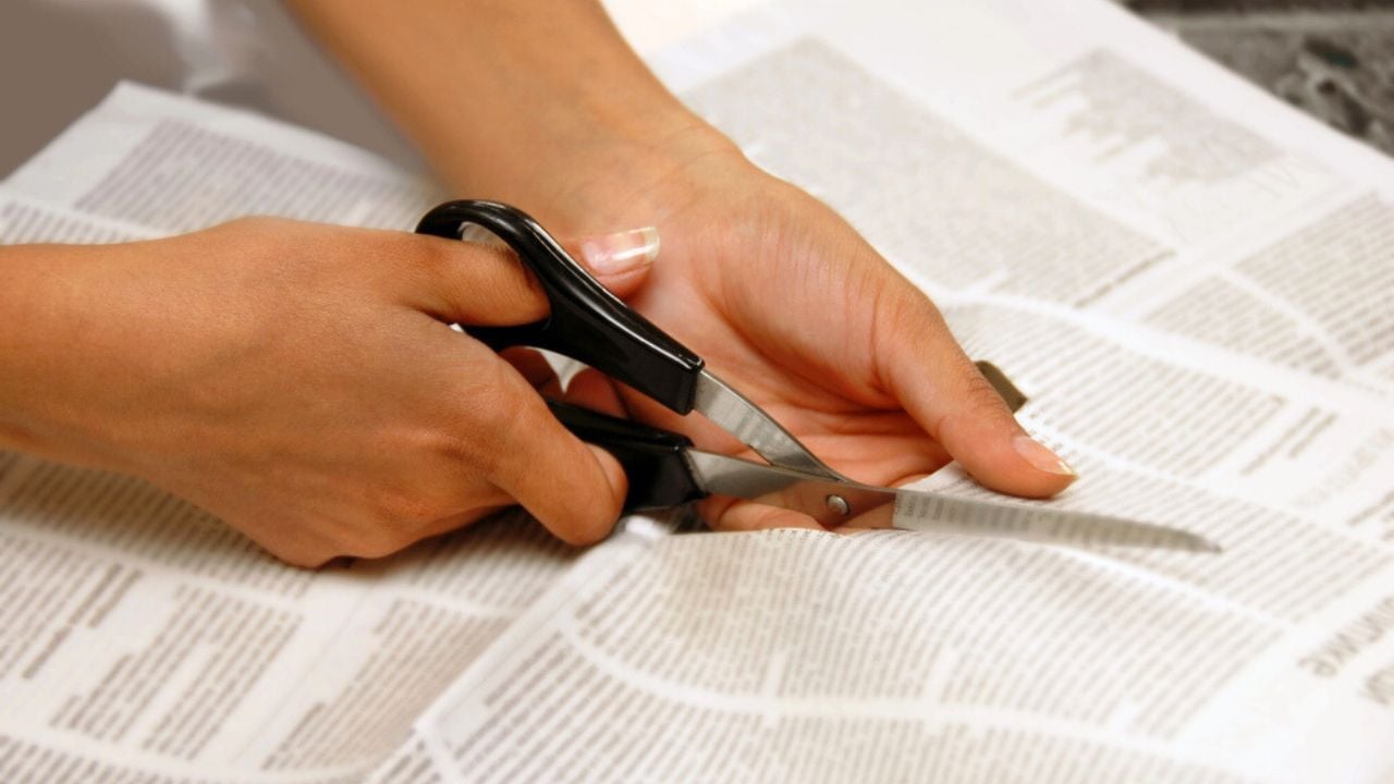 cutting newspaper