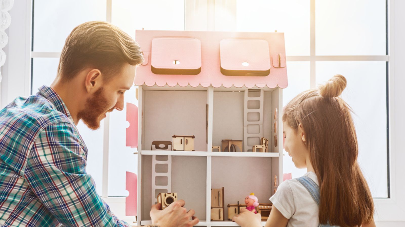 Father Playing with Daughter with her doll house