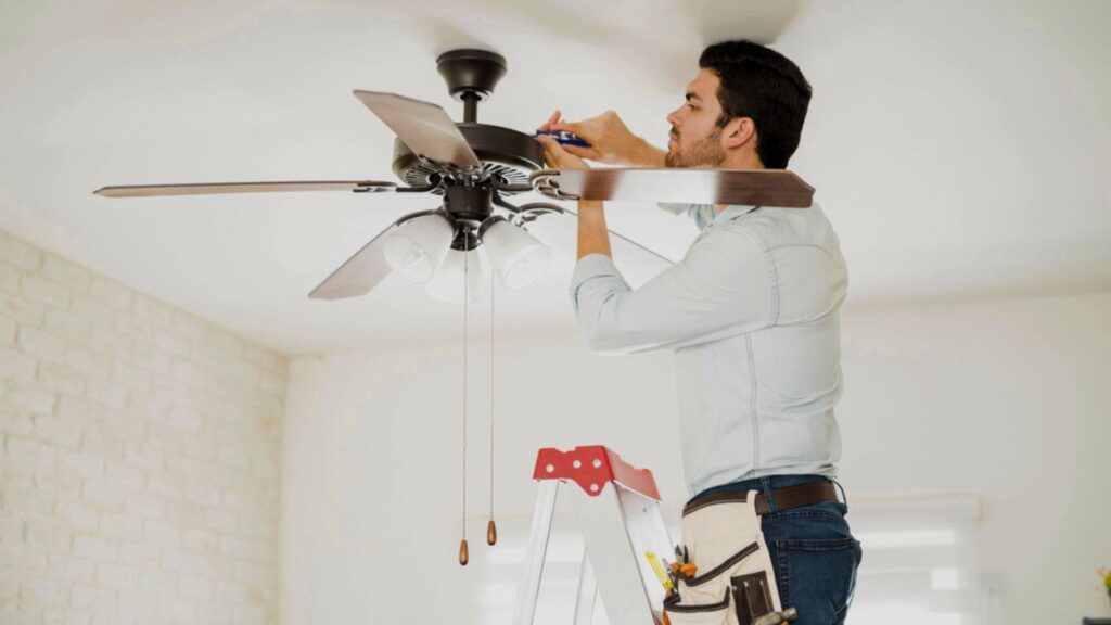 Handyman installing a ceiling fan