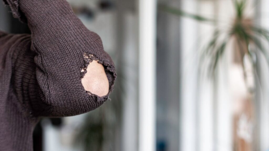 Hole on the sleeve worn to holes fabric