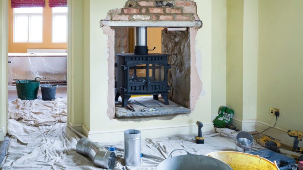 Installing a double-sided wood burning stove during a UK home improvement project