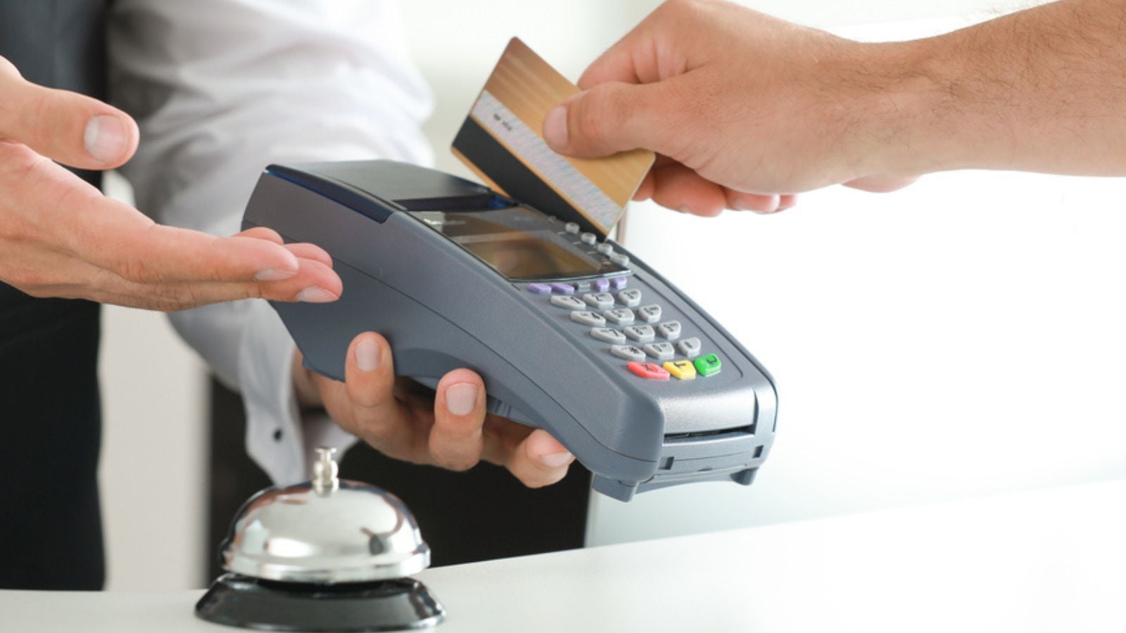 Man paying for hotel room at reception, closeup