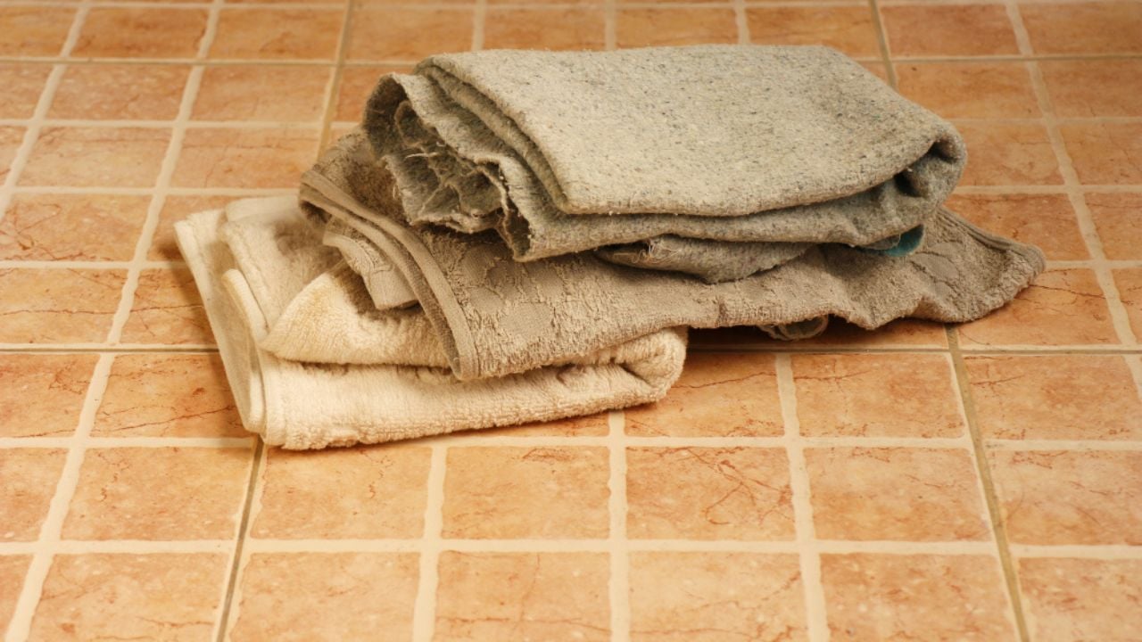 Old cloth on brown square brick wall texture background