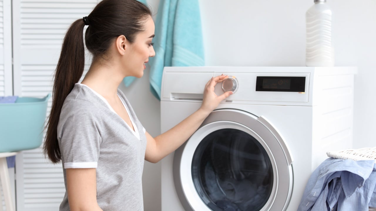 Young woman doing laundry at home