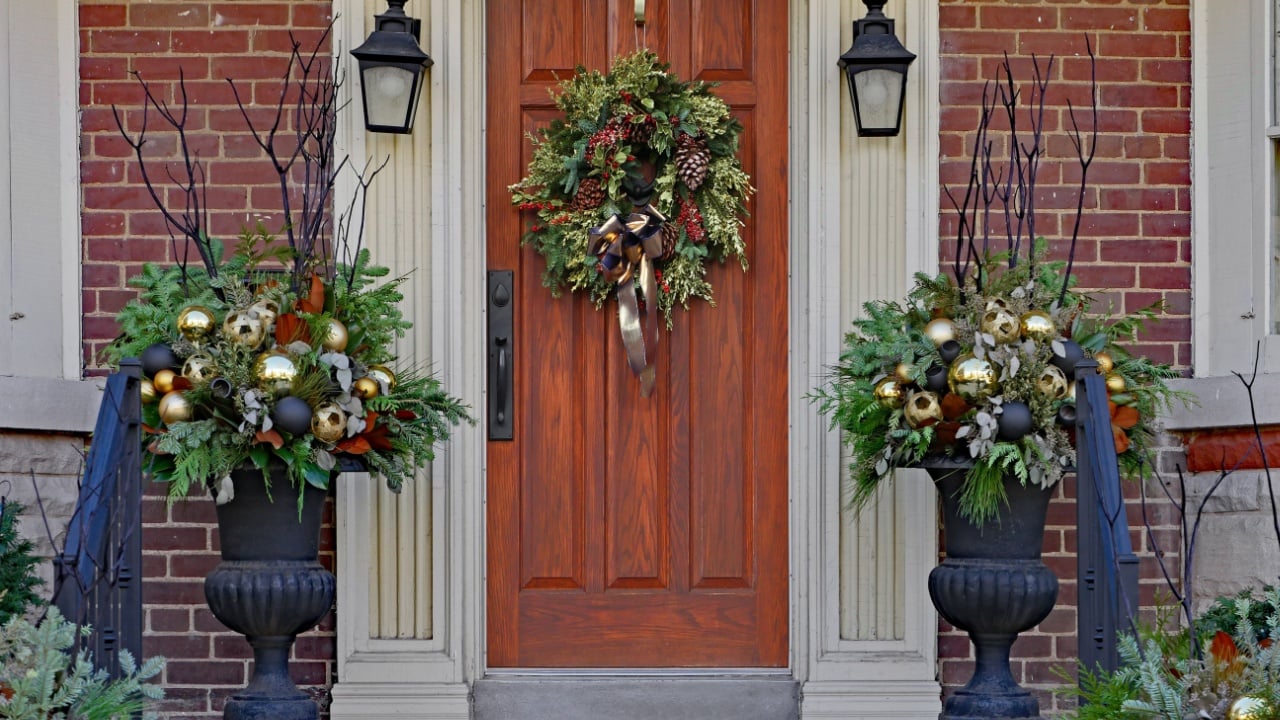 wooden front door with wreath and festive decorations