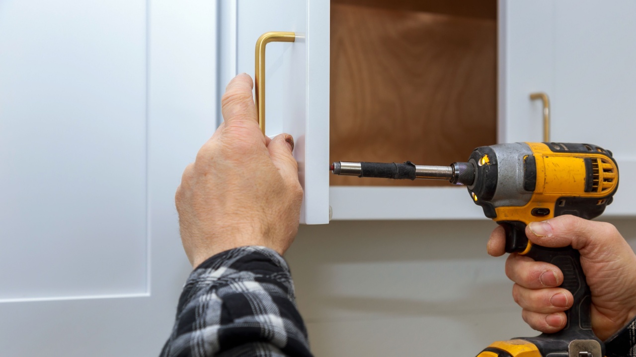 The installing a furniture handle process of assembling cabinet