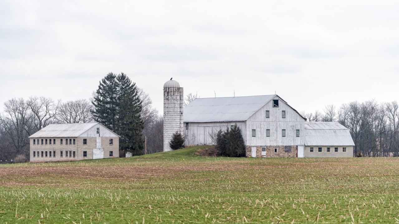 Mechanicsburg, USA - April 6, 2018: Rural Pennsylvania farm countryside mountain scenery in spring with house and silo farmhouse building