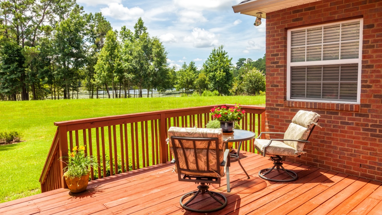 Backyard deck overlooking lake outside residential structure