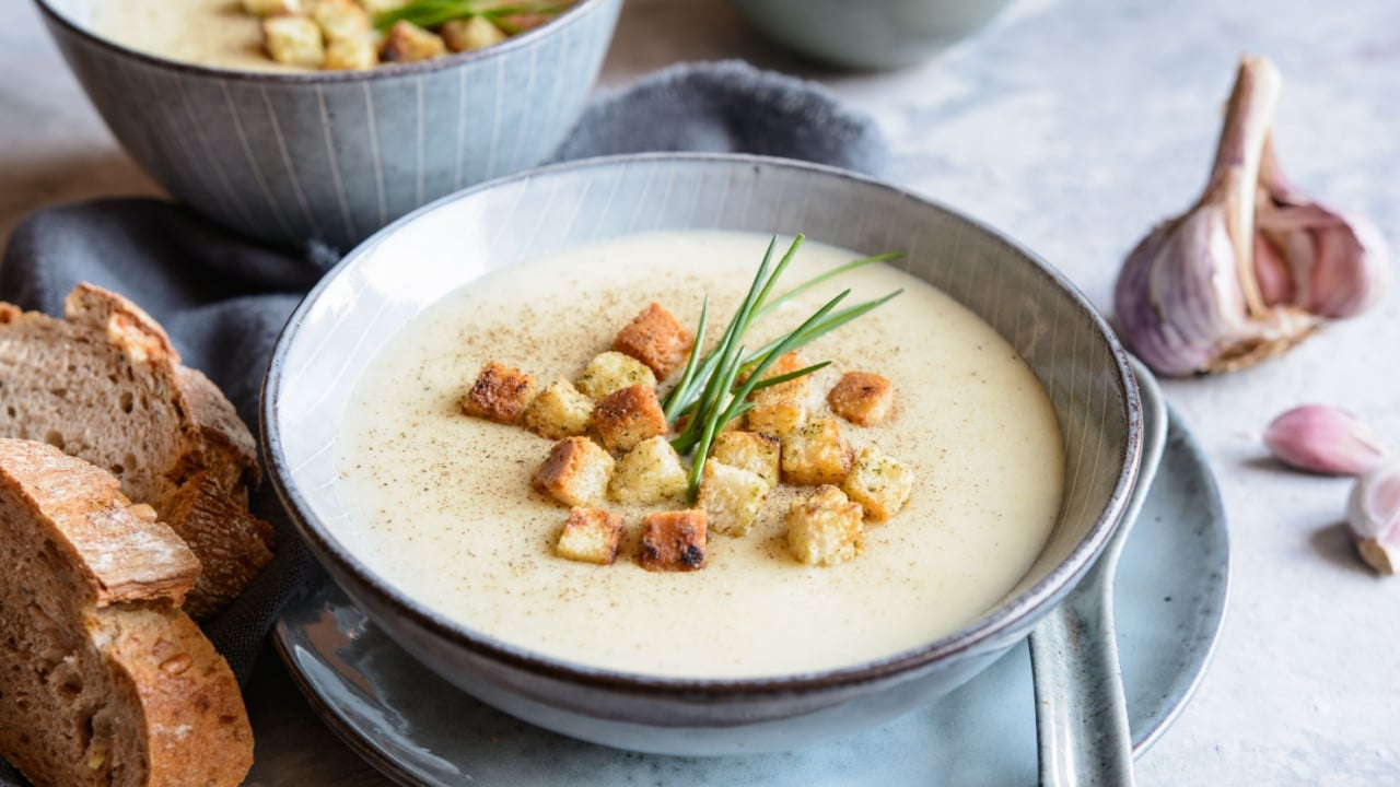 Easy to make creamy garlic soup topped with croutons and chives