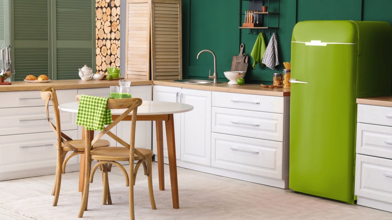 Interior of modern kitchen with dining table and green vintage refrigerator