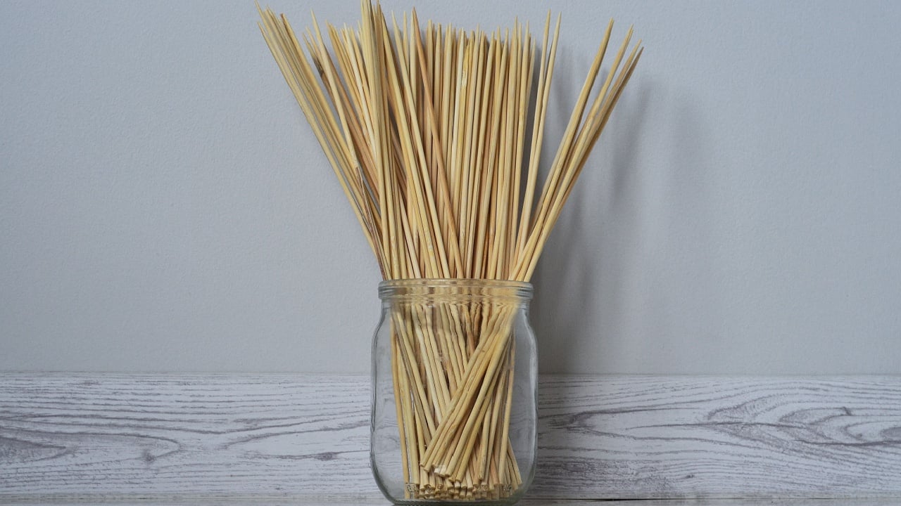There are long wooden skewers in the jar
