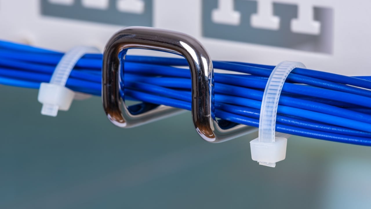 Electric cable cord on hook of organizer, close-up view