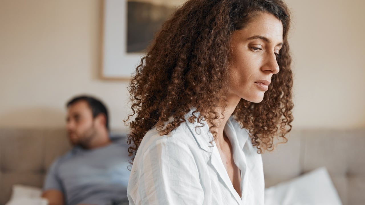 Upset, bedroom and woman in argument with her husband for divorce, marriage problem or breakup. Sad, depression and female person fighting with her partner for toxic relationship or cheating at home.