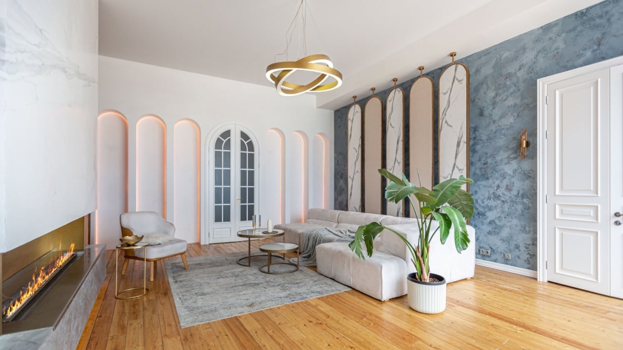 cozy interior of a modern living room with a fireplace, decorative panels and LED lighting with soft daylight, without people, in pastel colors.