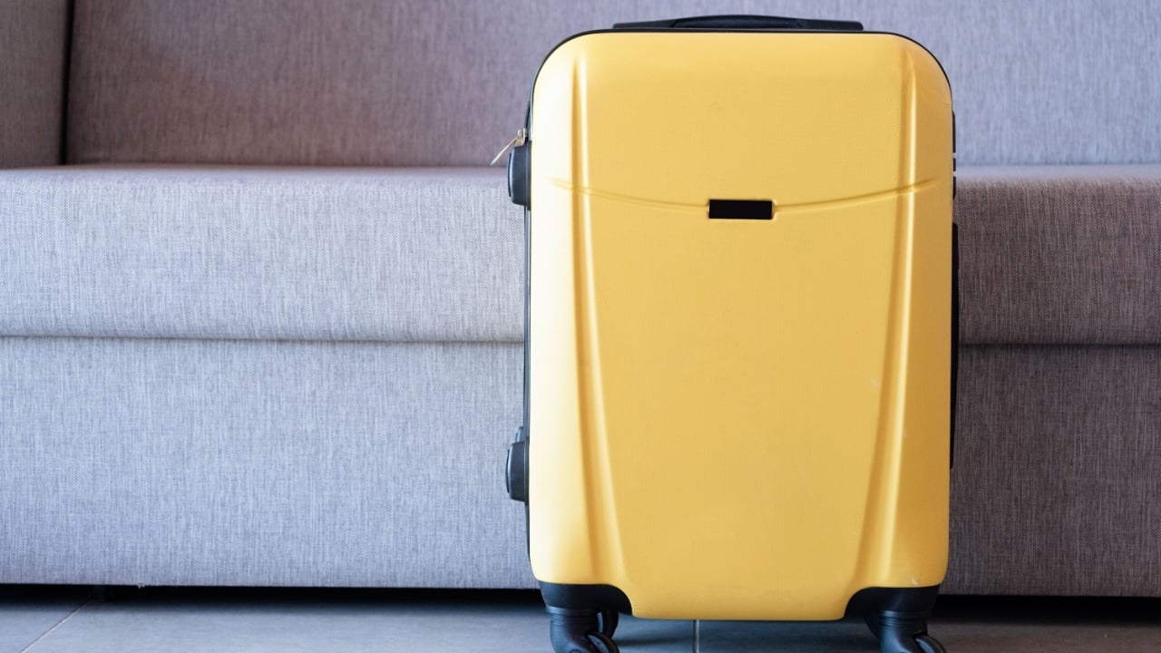 yellow suitcases on sofa background in hotel room,
