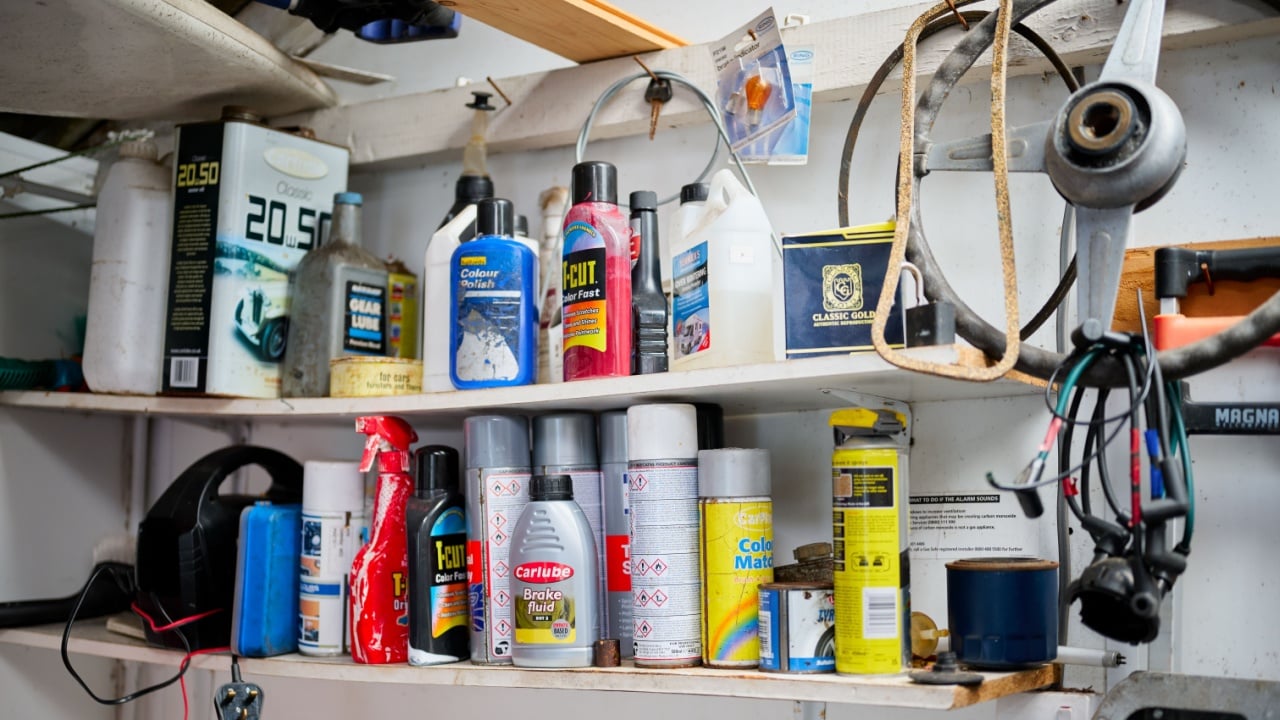 Manchester, UK, 01, December, 2024: Assorted car maintenance products on shelves in a garage workshop.