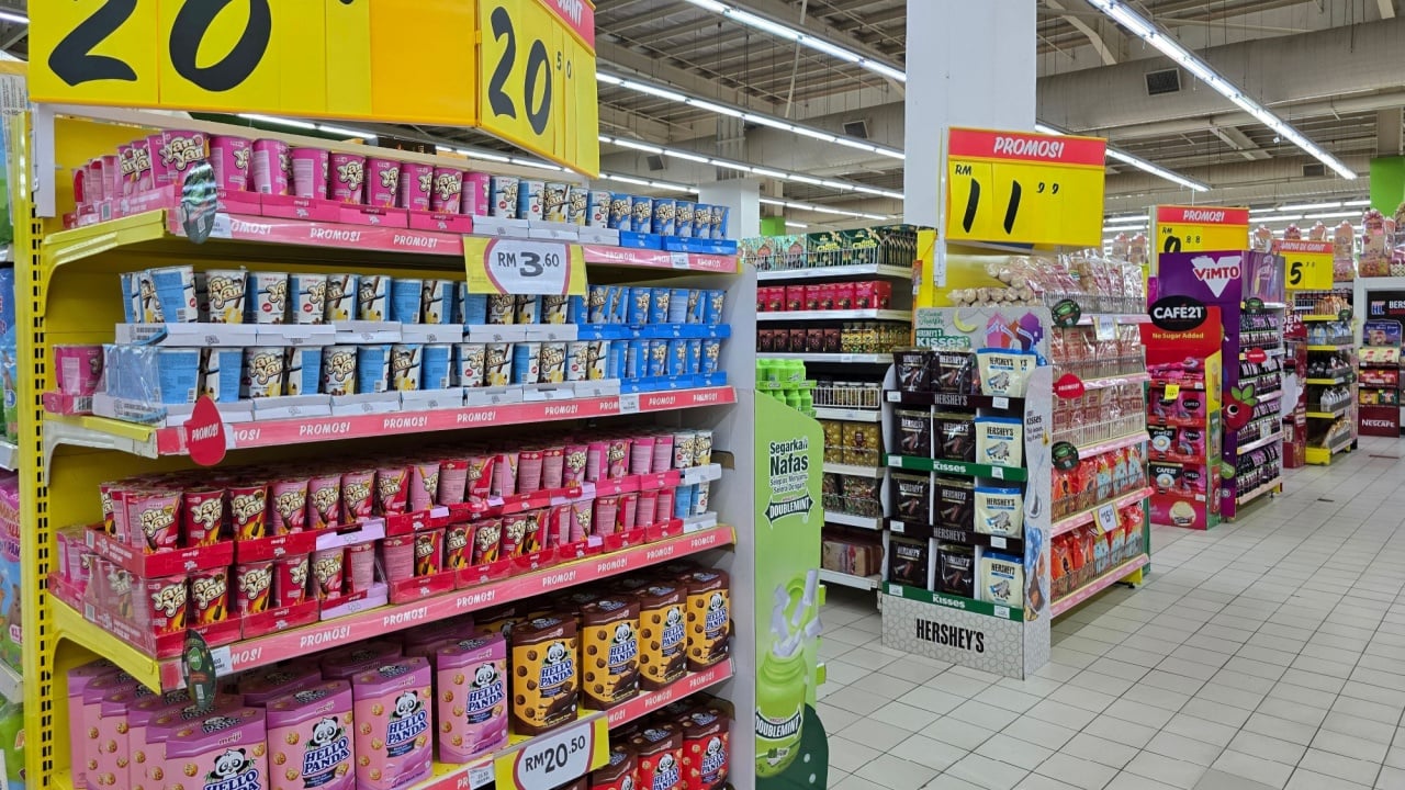 Penang, Malaysia &ndash; May 5, 2025: Colorful promotional display of Hello Panda and Yan Yan biscuit snacks at Giant Grocery with large yellow price tags and promotional signage.