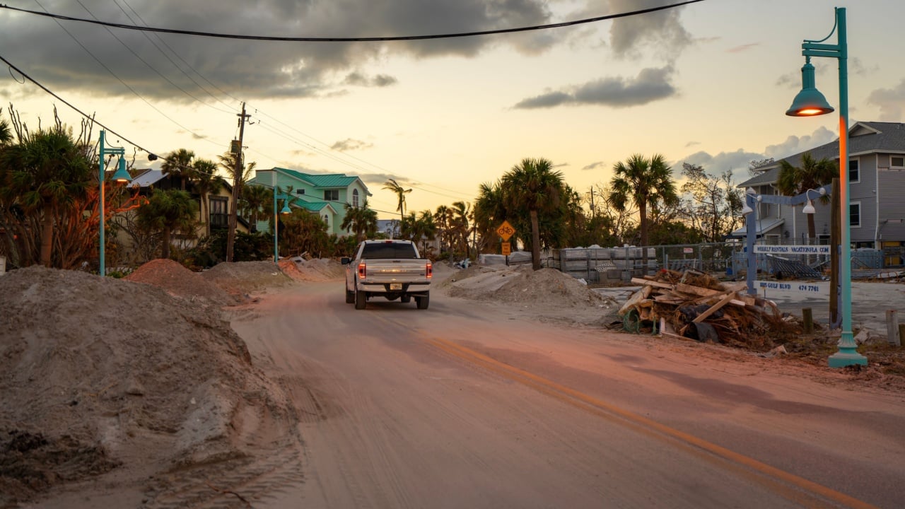 Cleanup efforts after hurricane in Florida. Piles of debris and construction waste on streets of Manasota Key, severe impact on local homes and infrastructure. Englewood, USA - October 22, 2024.