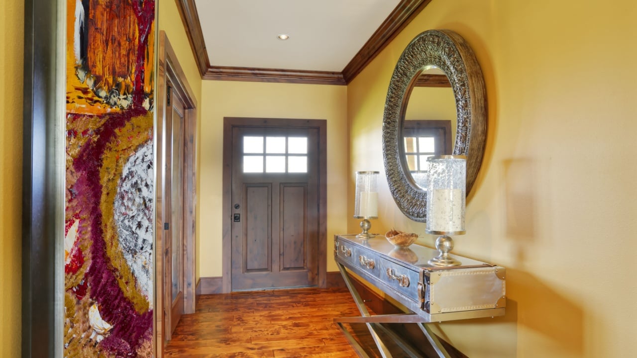 Entryway with vintage console table with drawers and round mirror on the wall. Northwest, USA