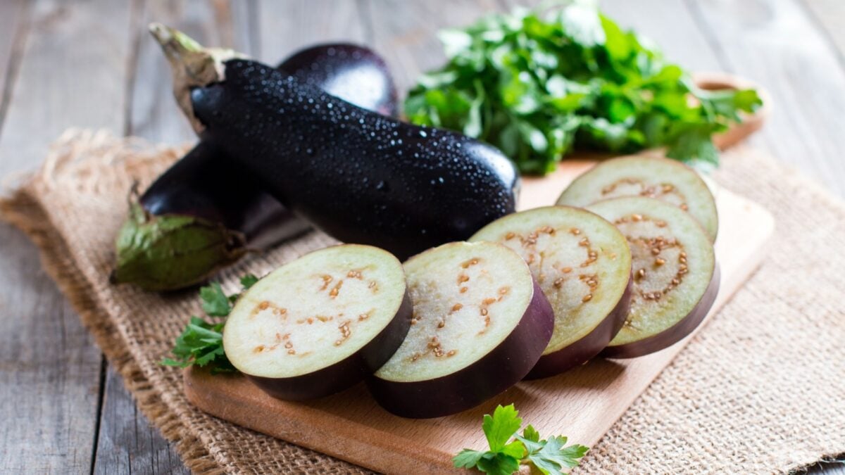 Sliced eggplant on wooden cutting board