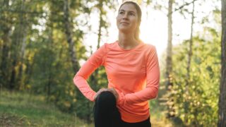 a woman stretches before running