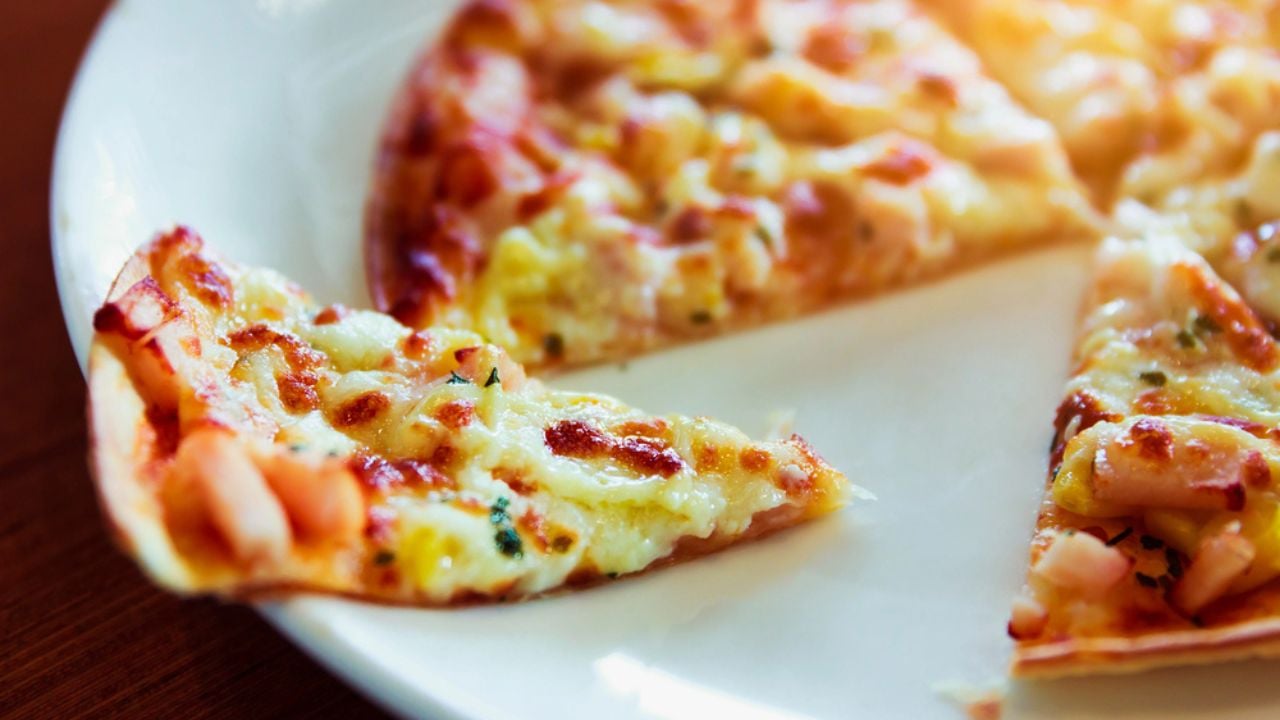 Tortilla Pizza with mozzarella cheese, imitation crab stick on white plate for your advertising.