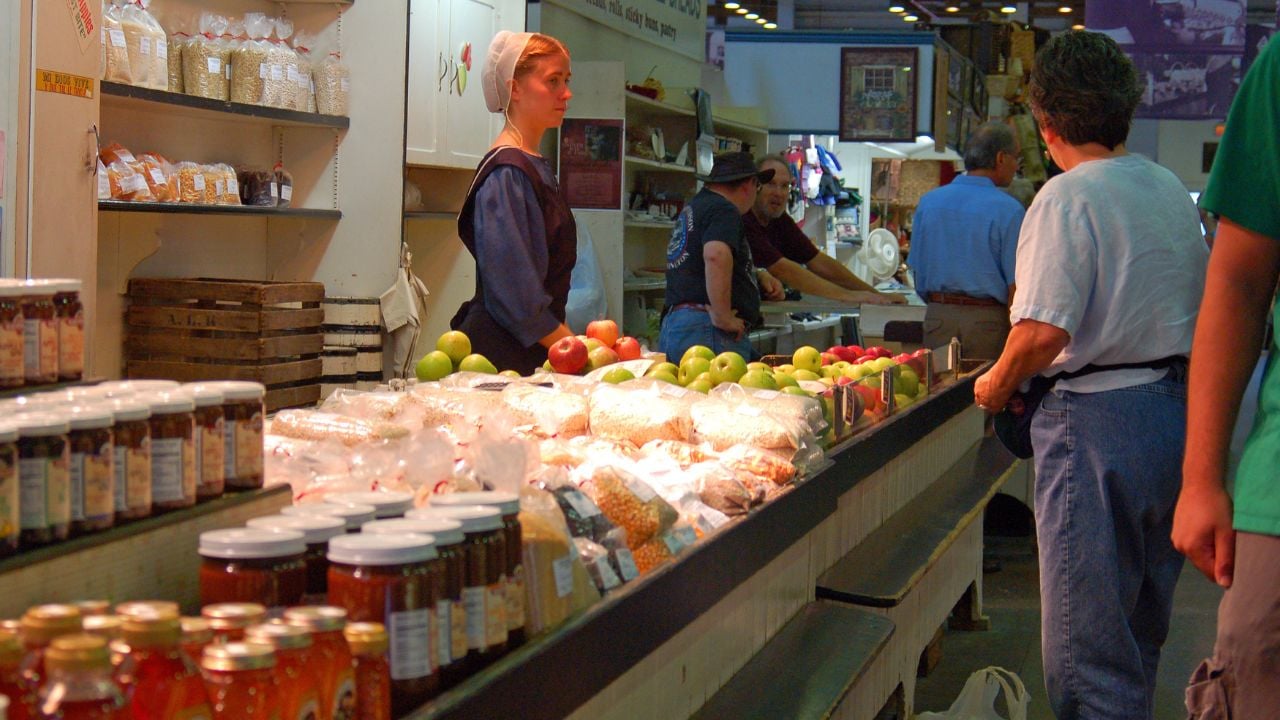 A Mennonite woman minds an organic food stall in Lancaster, Pennsylvania