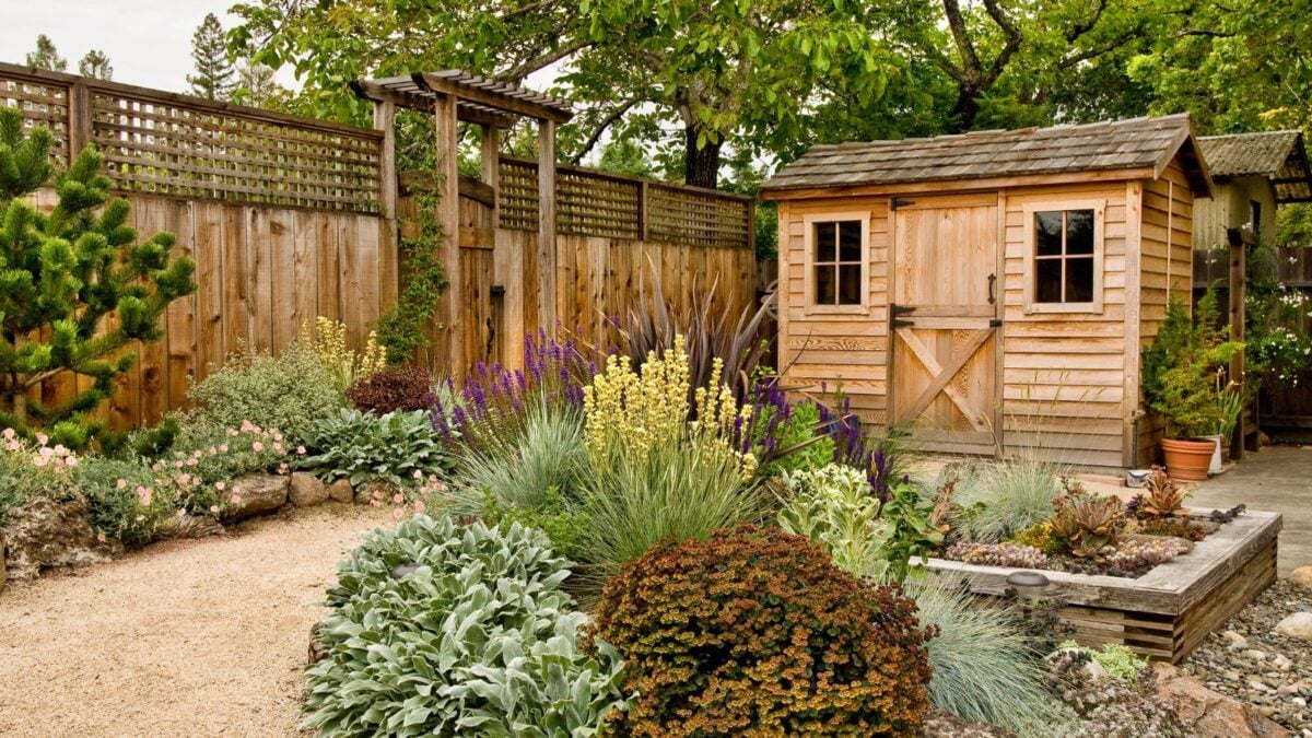 wooden storage shed nicely landscaped.