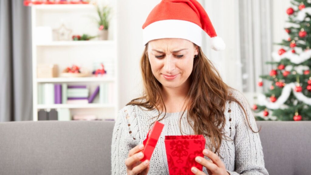 Young girl is sad about christmas gift