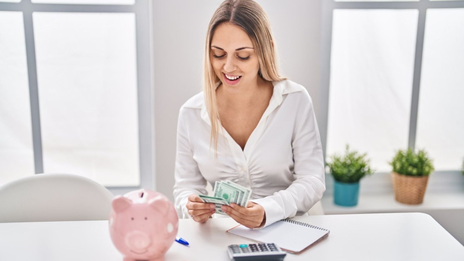 young woman counting cash money budgeting piggy bank